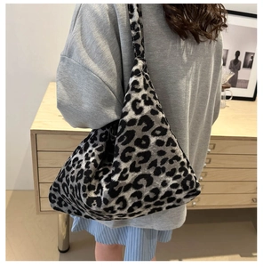 Detail of hobo shoulder bag featuring stylish leopard print and soft knitted texture