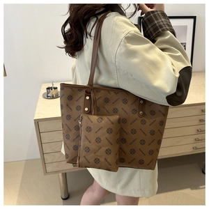 Brown monogram tote bag set shown on shoulder with spacious interior and matching pouch
