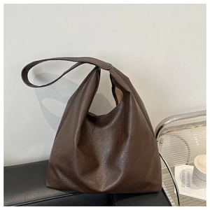 Detail view of the deep brown large tote bag with textured lychee grain synthetic leather