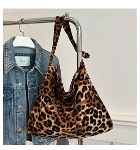 Detail of trendy leopard print canvas tote bag with knot strap detail and spacious interior