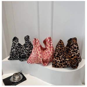 Three color options of leopard print canvas tote bags displayed on a white stand