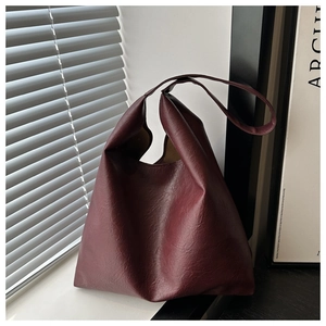 Detailed view of dark red leather tote bag showing soft texture and spacious opening