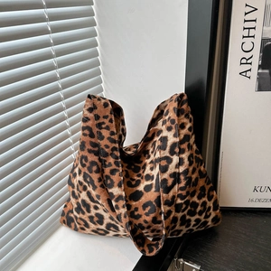 Large leopard print knit tote bag for women with dual wide shoulder straps in room setting