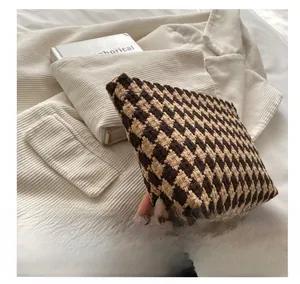 Close-up of houndstooth woven fabric on a long zip wallet with premium texture