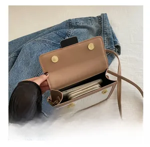 Detail of crossbody bag interior showing phone and wallet capacity with stone pattern