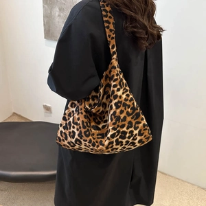 Chic leopard print canvas tote bag for women featuring a spacious interior and wide strap