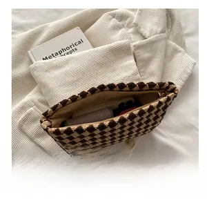 Detailed interior view of a houndstooth plaid wallet showing its large storage capacity