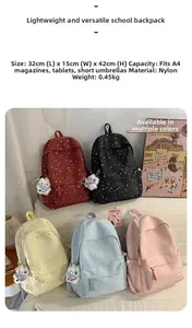 Detail showing colorful nylon star backpacks with 32x15x42cm dimensions and plush charms