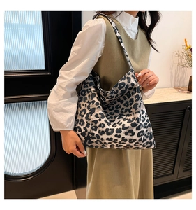 Detailed view of large fabric tote bag with black and white leopard print on shoulder