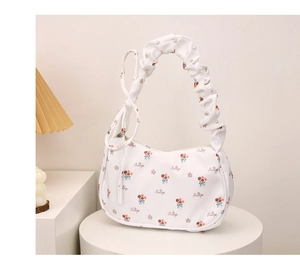 Detail of floral hobo bag featuring fabric pleats and elegant bow knot decoration