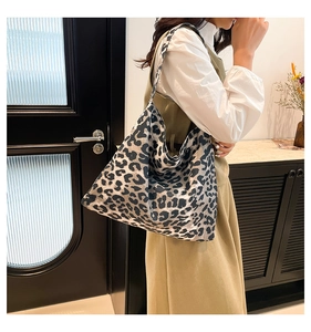 Close-up of leopard print canvas tote bag showing soft fabric texture and large capacity