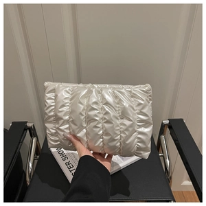 Detailed view of the white quilted cloud bag with glossy finish and puffy ripple texture