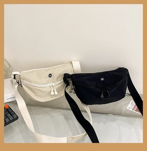 Detail view of stylish crescent nylon crossbody bags with dual zippers and woven strap