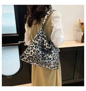 Macro shot of large leopard print tote bag fabric showing durable canvas texture