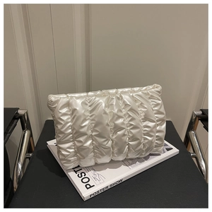 Detailed view of pearl white pleated cloud clutch bag with silky fabric texture
