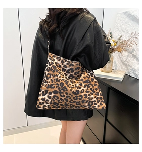 Fashionable large leopard print tote bag shown on model back for scale and style