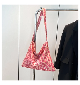 Detailed shot of pink leopard print tote bag fabric and soft shoulder strap design