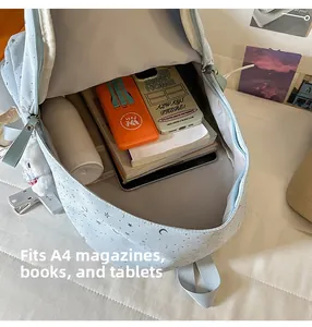 Spacious interior of blue star backpack holding A4 books and a tablet