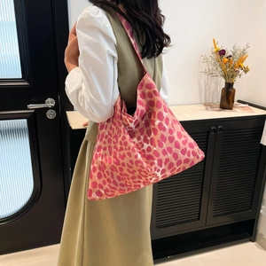Pink and orange leopard print canvas tote bag shown as a spacious shoulder bag style