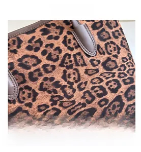 Close-up of leopard print tote bag texture and high-quality brown leather handle detail