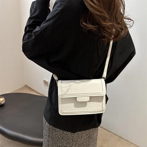 White faux leather crossbody bag with stone texture and adjustable shoulder strap