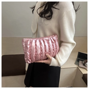 Detail of pink puffy cloud bag with metallic finish and horizontal quilted texture