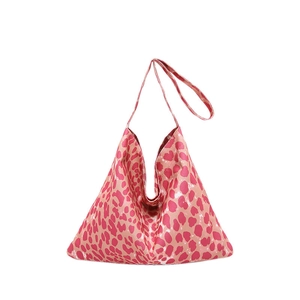 Pink leopard print shoulder tote bag with a unique triangular geometric structure