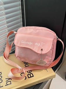 Pink nylon crossbody camera bag with cute sausage dog print and acrylic charm accessory