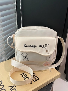 Minimalist cream white crossbody bag with cute sausage dog illustration and acrylic charm