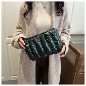 Detailed view of the dark green quilted nylon handbag with a soft padded cloud texture