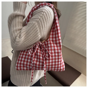 Detail of red and white gingham canvas tote bag featuring a cute side bow ribbon tie
