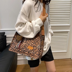 Stylish large leopard print tote bag for women with wide shoulder straps and bear charm
