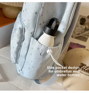 Functional side pocket of light blue star pattern backpack holding a water bottle
