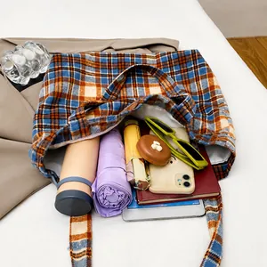 Interior view of plaid tote bag showing large capacity for umbrella, phone, and notebook