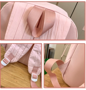 Close-up of pink travel backpack featuring reinforced handle and adjustable plastic buckle