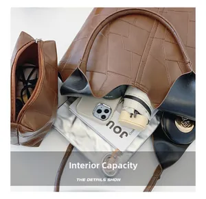 Detail view of interior capacity showing a large tote bag with laptop and daily essentials