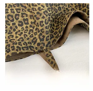 Close-up of precise stitching on leopard print canvas tote bag with dark brown lining