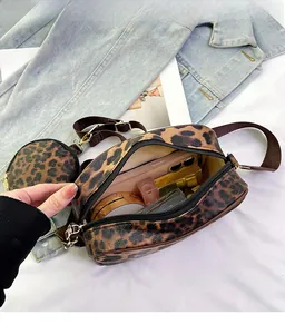 Detailed interior of leopard print crossbody bag showing spacious storage for cosmetics