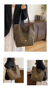 Detailed close-up of large leopard print canvas tote bag with golden handmade metal plate