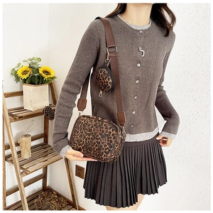 Detailed view of leopard print crossbody bag set with adjustable nylon strap and coin purse
