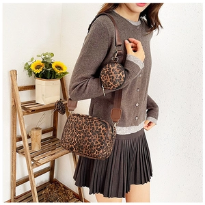 Detailed view of leopard print crossbody bag set with adjustable canvas shoulder strap