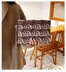 Detail of leopard print clutch bag with zipper closure and wrist strap for daily use