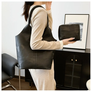 Chic black tote bag set with geometric patchwork texture and matching clutch for women