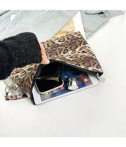Detail shot of leopard print canvas clutch showing spacious interior for tablet and makeup