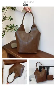 Detail view of coffee brown textured leather tote bag with matching inner storage pouch