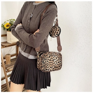 Fashion leopard print crossbody bag set worn by model with wide strap and round coin purse