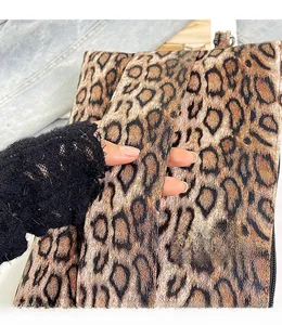 Detailed close-up of leopard print handbag showing woven texture and comfortable handle