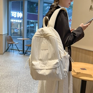 Minimalist cream white nylon backpack with crinkle texture for school and casual travel