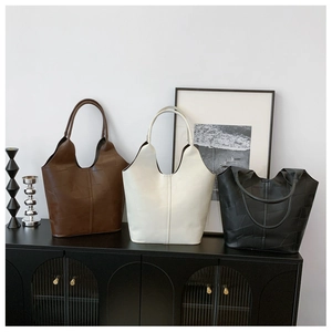 Detailed view of three vintage tote bags in brown, white and black with geometric texture
