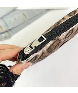 Close-up of leopard print bag featuring a functional silver front zipper detail